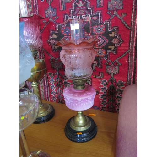 584 - A Victorian oil lamp with pink glass Reservoir