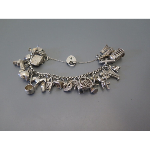 72 - A silver charm bracelet, 71 g