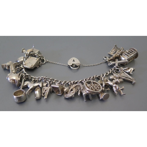 72 - A silver charm bracelet, 71 g