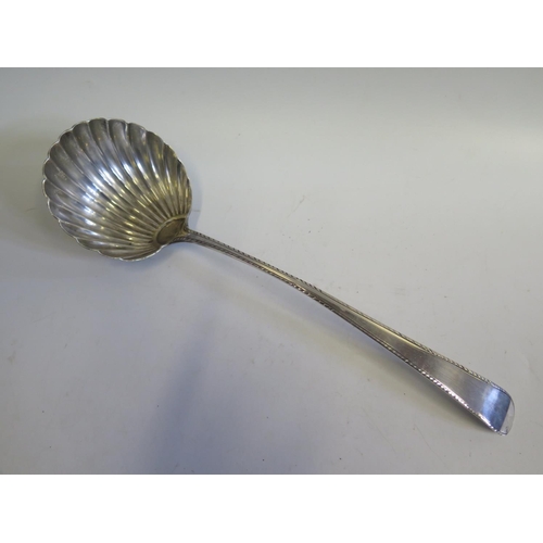 46 - An Early 19th Century Bright Cut Silver Soup Ladle with scalloped bowl, possibly provincial, maker's... 