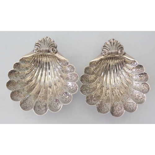 1 - A Pair of Elizabeth II Silver Scallop Shaped Dishes with chased foliate decoration and raised on thr... 