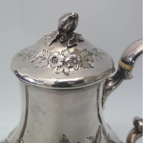 17 - A Victorian Silver Coffee Pot with embossed foliate decoration, London 1869, William Comyns & Sons, ... 