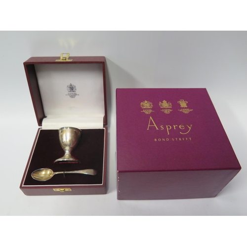 41a - An Elizabeth II Silver Christening Egg Cup and Spoon in fitted case and with outer box, London 1988,... 