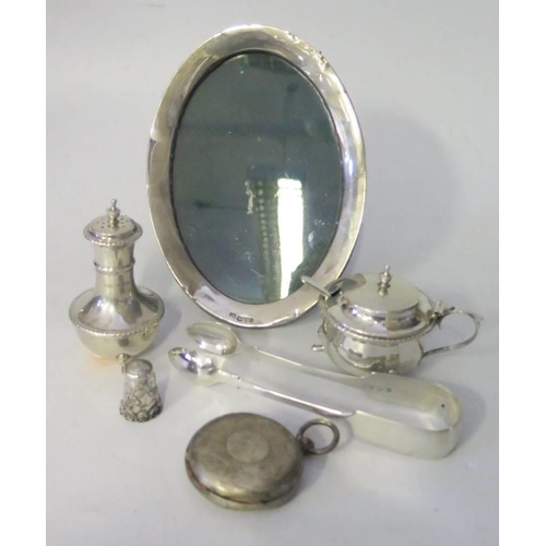 69 - A Selection of Silver including a pepper, mustard, sugar tongs, photo frame, pocket watch and thimbl... 