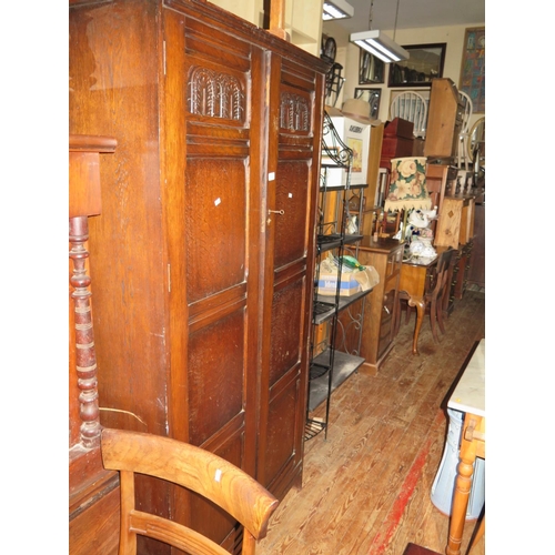 714 - A Carved Oak Double Wardrobe