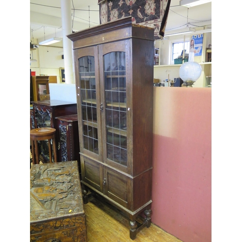 734 - An Oak Leaded and Glazed Bookcase with cupboard below