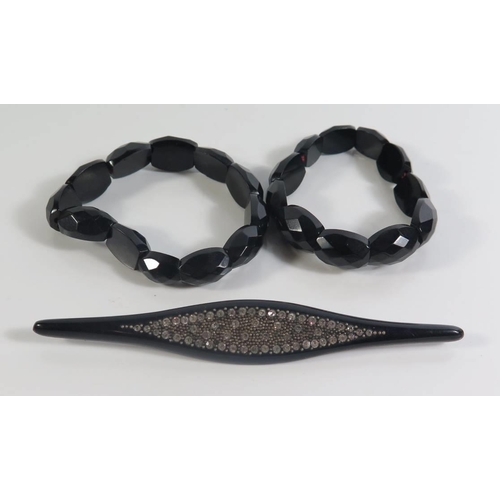 83 - A Whitby Jet and Paste Brooch and two faceted bracelets