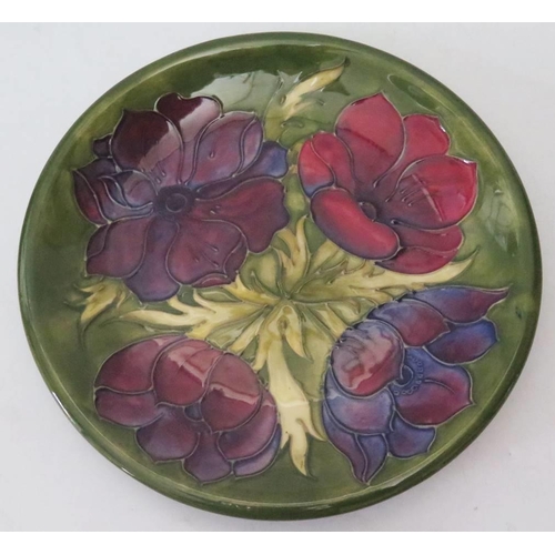 257 - A Moorcroft Green Ground Floral Decorated Plate, 25.5cm