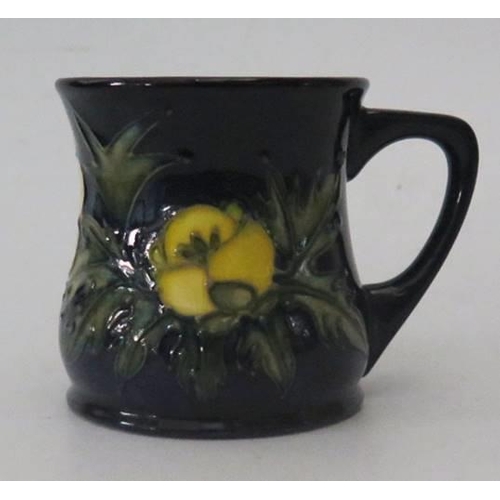 258 - A Moorcroft Blue Ground Floral Decorated Trio with matching mug