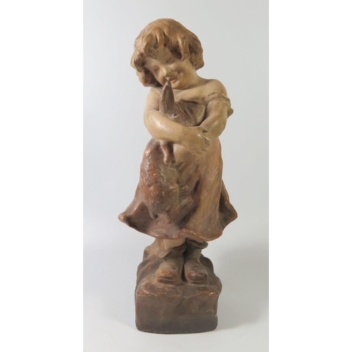 266 - A Friedrich Goldscheider Terracotta Model of a young girl holding pet rabbit, 37cm tall