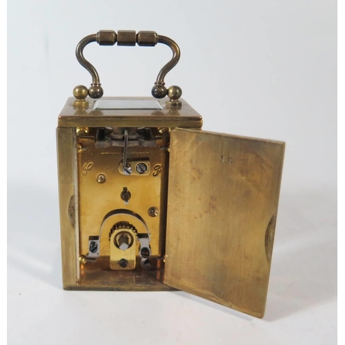 276 - A Small French Brass French Brass Carriage Clock in original leather carrying case, 8.5cm to top of ... 