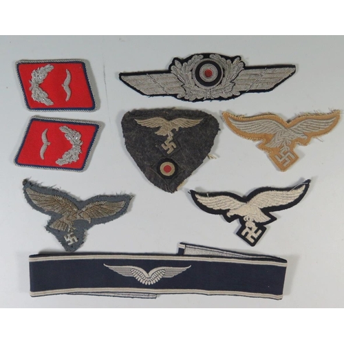 316 - A Collection of WWII German Luftwaffe Cloth Badges: pair of collar tabs, 2 x breast eagle, cockade, ... 