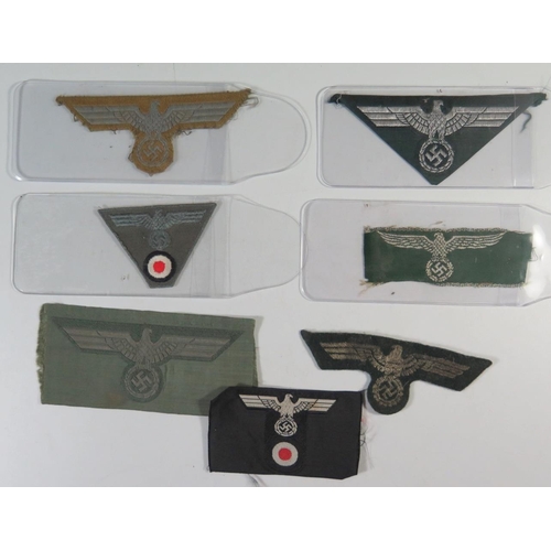 318 - Six WWII German Army Cloth Eagle Badges and one Customs cloth eagle