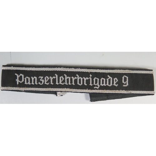 323 - A WWII Gerrman Panzerlehrbrigade 9 Cuff Title complete with SS issue label on the back