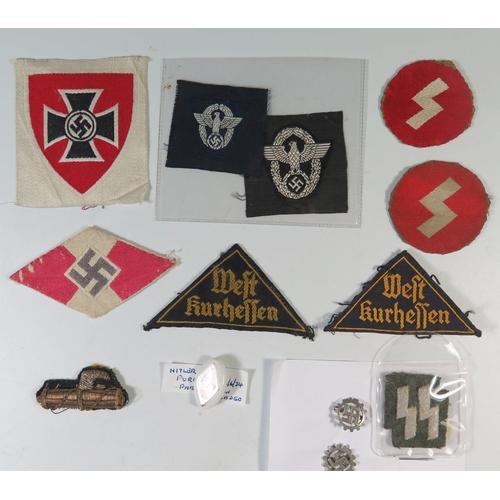 325 - A Collection of WWII and earlier German insignia including: two police eagles, Hitler Youth cloth ba... 