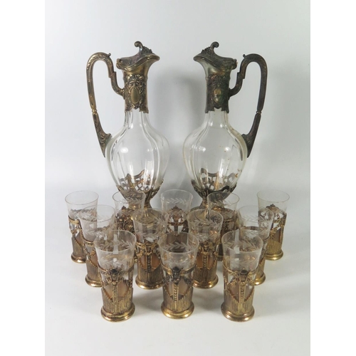 49 - A German .800 Silver Gilt Twin Wine Ewer Set with twelve matching silver and glass beakers, stamped ... 