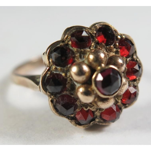 140 - A 9ct Gold and Garnet Dress Ring, size L.5, 4.4g