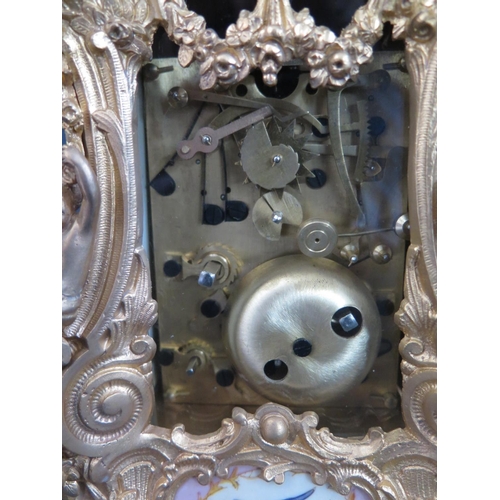 331 - An Ornate Repeating Carriage Clock with porcelain dial and panels, 23cm high, running