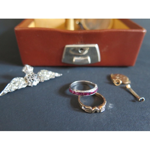 35 - An Unmarked Chanel Set Ruby Ring in a precious white metal setting (2.3g), 10K gold 'LOVE' ring (1.7... 