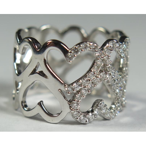 80 - An 18ct White Gold and Diamond Conjoined Hearts Ring, size S.5, 9.6g