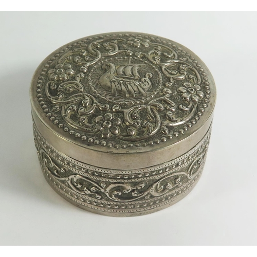 146b - A .800 Silver Box decorated with embossed foliate work and ship, Cyrillic marks, 8.5cm diam., 135g