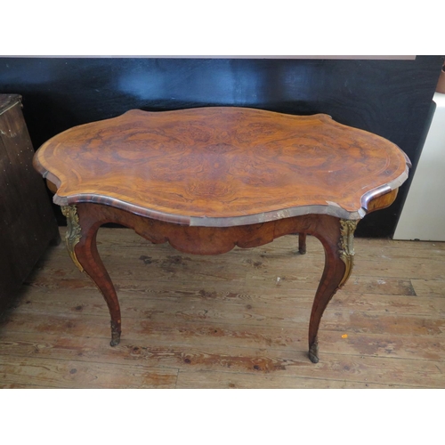 472 - A 19th Century French Burr Walnut Centre Table with a quarter veneered and crossbanded top, gilt bro... 