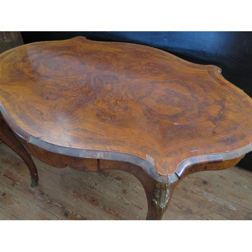 472 - A 19th Century French Burr Walnut Centre Table with a quarter veneered and crossbanded top, gilt bro... 