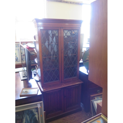 661 - An Oak Linenfold Leaded and Glazed Bookcase with cupboard below