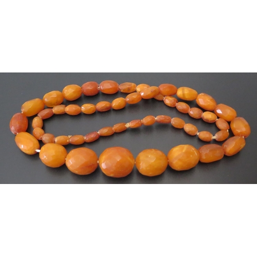 645a - A Baltic Amber Faceted Graduated Bead Necklace, c. 80cm, lagest bead 27x 23mm, 75.3g