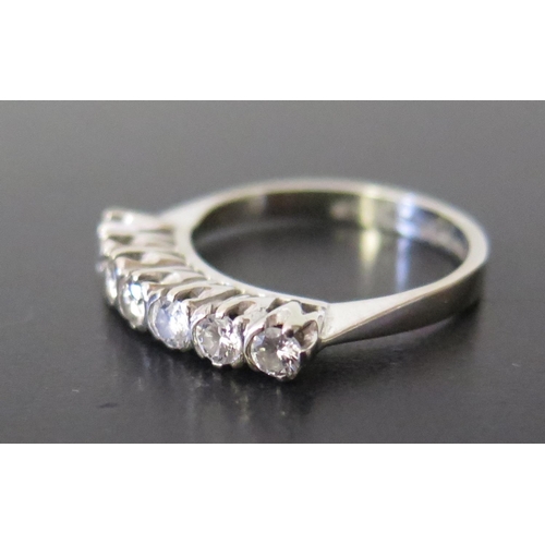 653 - An 18ct White Gold and Diamond Seven Stone Ring, size L, 3.9g