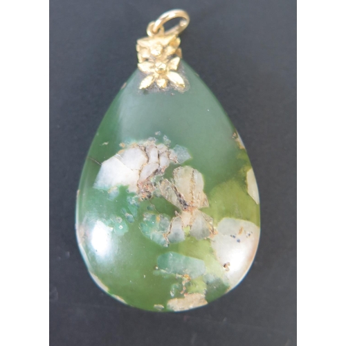 670 - A Jade Tear Drop Pendant with yellow metal mount, 52mm drop