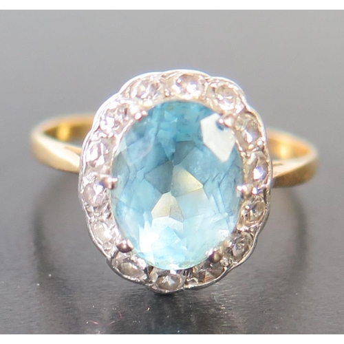 676 - An Aquamarine and Diamond Cluster Ring, aquamarine  9x7mm, size N, 2.2g