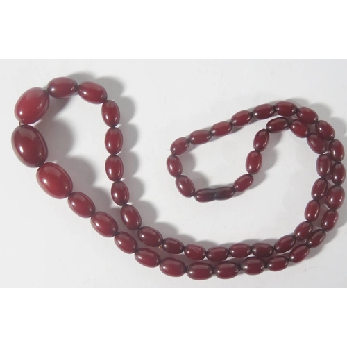 42B - A Red Faux Amber Bead Necklace, 48.7g, largest bead 24x17mm, 74cm long

***PHONE BID***