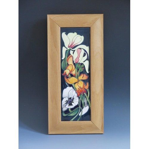 105 - A Modern Moorcroft Miss Alice Pattern Plaque dated 2005 and framed by The Art Studio, 40x19cm overal... 