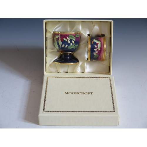 108 - A Modern Moorcroft Enamel Egg Cup and Napkin Ring Boxed Set decorated with berries, dated 03