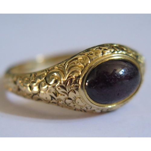 598 - A Georgian Foil Back Cabochon Purple Garnet Ring in a high carat unmarked gold setting with chased f... 