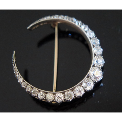 608 - A Victorian Diamond Crescent Brooch in a precious yellow and white metal mount, largest diamond esti... 