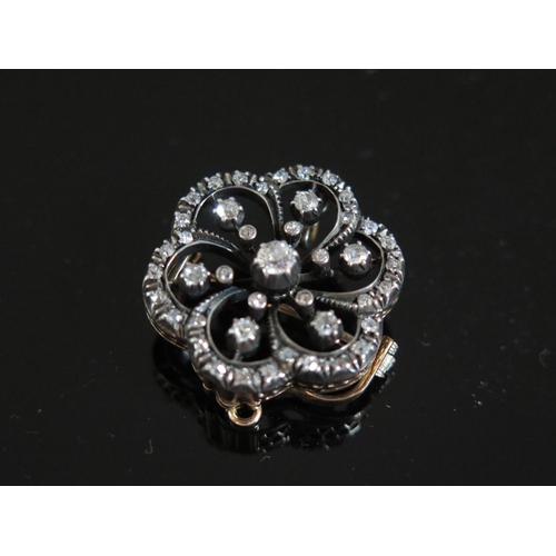 609 - A Victorian Diamond Pendant Brooch, central diamond estimated .17ct, 25mm diam., 7.7g