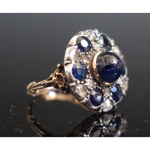 614 - An Antique Cabochon and Round Cut Sapphire and Rose Cut Diamond Dress Ring in a foliate high carat g... 