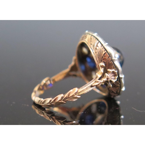 614 - An Antique Cabochon and Round Cut Sapphire and Rose Cut Diamond Dress Ring in a foliate high carat g... 