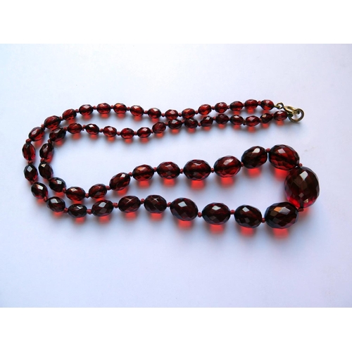 617 - A Graduated Faceted Faux Cherry Amber Bead Necklace, 67cm, 32.1g