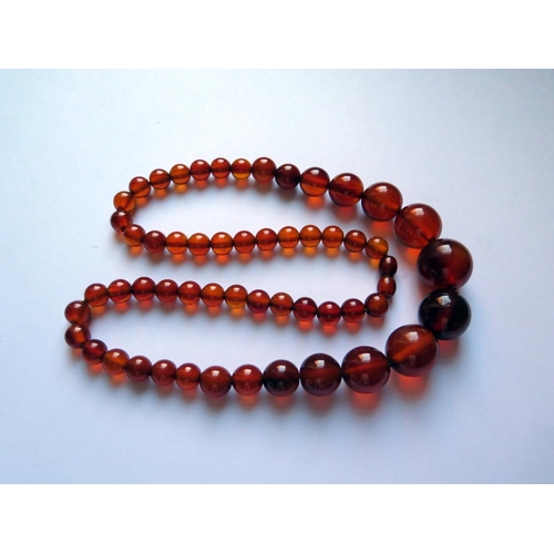 621 - A Graduated Faux Orange Amber Bead Necklace, 62cm, 65.5g