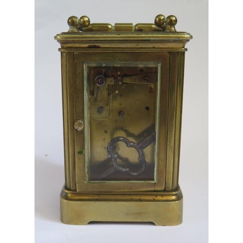 640 - A Metcalf & Co. Brass Carriage Clock with balance wheel to the back, 13cm to top of handle, running
... 