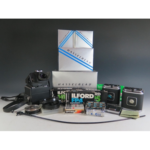 296 - A Hasselblad 500c/m Camera Body (boxed) with film cartridges, 40670 lense shade, 40711 Step-up ring,... 