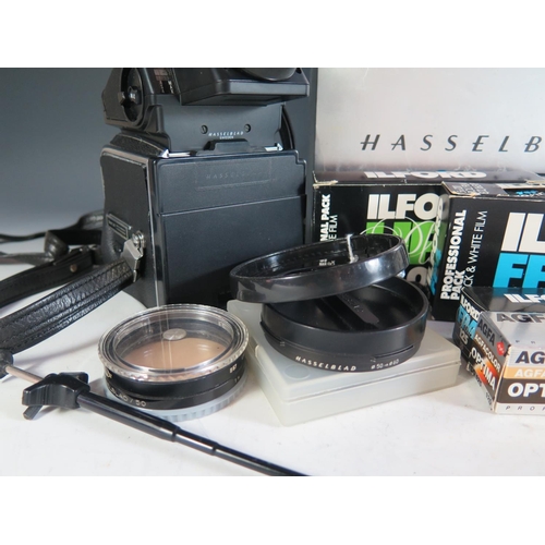 296 - A Hasselblad 500c/m Camera Body (boxed) with film cartridges, 40670 lense shade, 40711 Step-up ring,... 