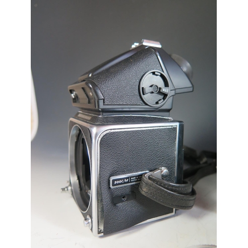 296 - A Hasselblad 500c/m Camera Body (boxed) with film cartridges, 40670 lense shade, 40711 Step-up ring,... 