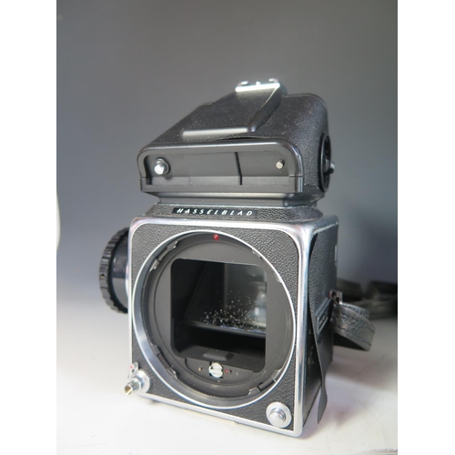 296 - A Hasselblad 500c/m Camera Body (boxed) with film cartridges, 40670 lense shade, 40711 Step-up ring,... 