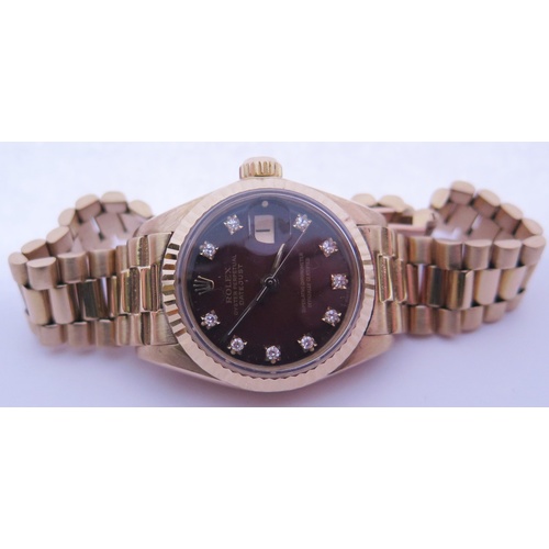 647B - A Ladies Rolex Oyster 18ct Gold Datejust Wristwatch with maroon diamond set dial, 2030 movement no. ... 