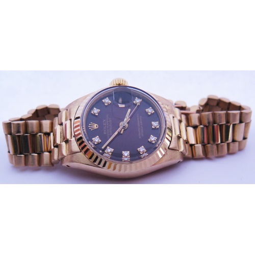 647B - A Ladies Rolex Oyster 18ct Gold Datejust Wristwatch with maroon diamond set dial, 2030 movement no. ... 