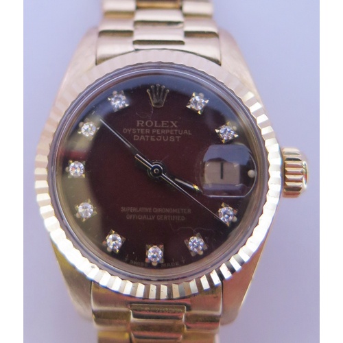 647B - A Ladies Rolex Oyster 18ct Gold Datejust Wristwatch with maroon diamond set dial, 2030 movement no. ... 